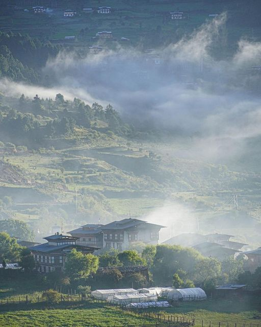 Morning mist drifting over Bumthang's valleys, farms and forested hills
